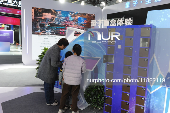 Visitors have a quantum blind box experience at the 2024 Quantum Technology and Industry Conference in Hefei, China, on November 30, 2024. 