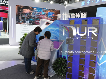 Visitors have a quantum blind box experience at the 2024 Quantum Technology and Industry Conference in Hefei, China, on November 30, 2024. (