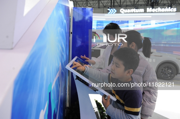 Visitors have a quantum blind box experience at the 2024 Quantum Technology and Industry Conference in Hefei, China, on November 30, 2024. 