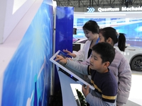 Visitors have a quantum blind box experience at the 2024 Quantum Technology and Industry Conference in Hefei, China, on November 30, 2024. (