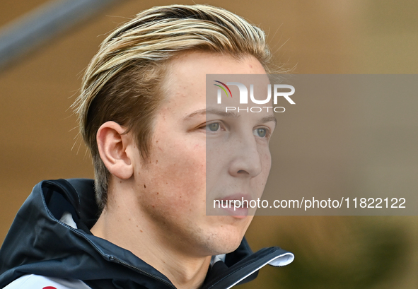 New Zealander Formula One driver Liam Lawson of RB walks through the paddock as he arrives ahead of the Formula 1 Grand Prix of Qatar at Lus...