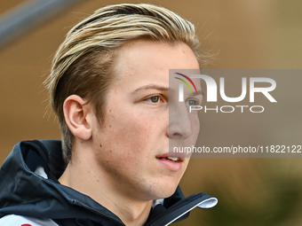 New Zealander Formula One driver Liam Lawson of RB walks through the paddock as he arrives ahead of the Formula 1 Grand Prix of Qatar at Lus...