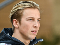 New Zealander Formula One driver Liam Lawson of RB walks through the paddock as he arrives ahead of the Formula 1 Grand Prix of Qatar at Lus...