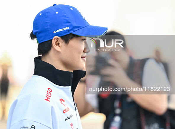 Japanese Formula One driver Yuki Tsunoda of RB walks through the paddock as he arrives ahead of the Formula 1 Grand Prix of Qatar at Lusail...