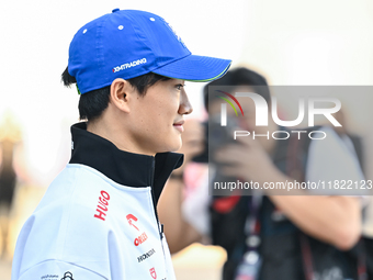 Japanese Formula One driver Yuki Tsunoda of RB walks through the paddock as he arrives ahead of the Formula 1 Grand Prix of Qatar at Lusail...