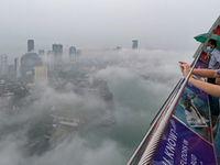 A foreigner takes a photograph of the city of Colombo amid smog and rain from Lotus Tower in Colombo, Sri Lanka, on November 30, 2024. Sri L...