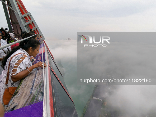 A woman looks at Colombo amid smog and rain from Lotus Tower in Colombo, Sri Lanka, on November 30, 2024. Sri Lanka's Central Environment Au...