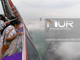 A woman looks at Colombo amid smog and rain from Lotus Tower in Colombo, Sri Lanka, on November 30, 2024. Sri Lanka's Central Environment Au...