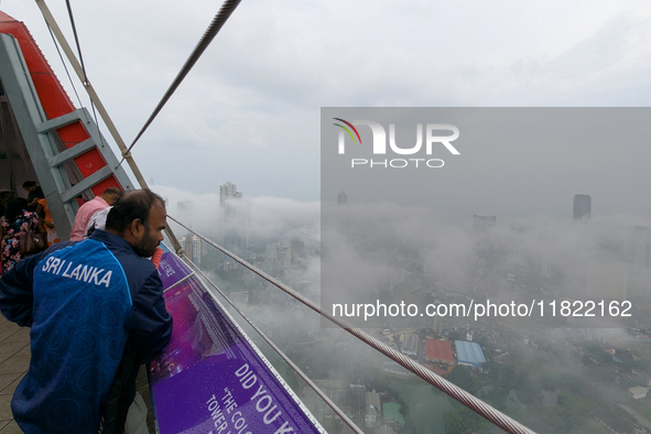 A man looks at the city of Colombo amid smog and rain from Lotus Tower in Colombo, Sri Lanka, on November 30, 2024. Sri Lanka's Central Envi...