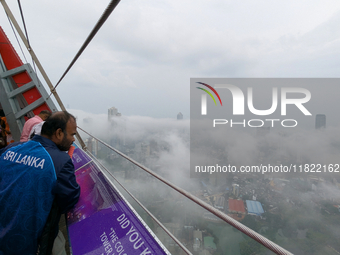 A man looks at the city of Colombo amid smog and rain from Lotus Tower in Colombo, Sri Lanka, on November 30, 2024. Sri Lanka's Central Envi...