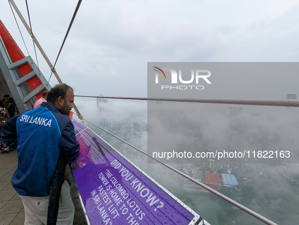 A man looks at the city of Colombo amid smog and rain from Lotus Tower in Colombo, Sri Lanka, on November 30, 2024. Sri Lanka's Central Envi...