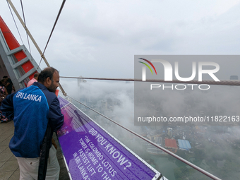 A man looks at the city of Colombo amid smog and rain from Lotus Tower in Colombo, Sri Lanka, on November 30, 2024. Sri Lanka's Central Envi...