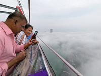 People look at the city of Colombo amid smog and rain from Lotus Tower in Colombo, Sri Lanka, on November 30, 2024. Sri Lanka's Central Envi...