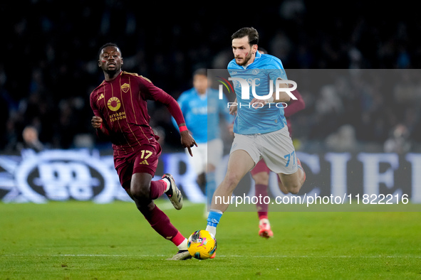 Khvicha Kvaratskhelia of SSC Napoli and Manu Kone' of AS Roma compete for the ball during the serie Serie A Enilive match between SSC Napoli...