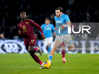 Khvicha Kvaratskhelia of SSC Napoli and Manu Kone' of AS Roma compete for the ball during the serie Serie A Enilive match between SSC Napoli...