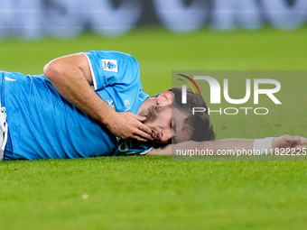 Khvicha Kvaratskhelia of SSC Napoli lies injured on the pitch during the serie Serie A Enilive match between SSC Napoli and AS Roma at Stadi...