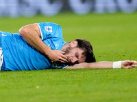 Khvicha Kvaratskhelia of SSC Napoli lies injured on the pitch during the serie Serie A Enilive match between SSC Napoli and AS Roma at Stadi...