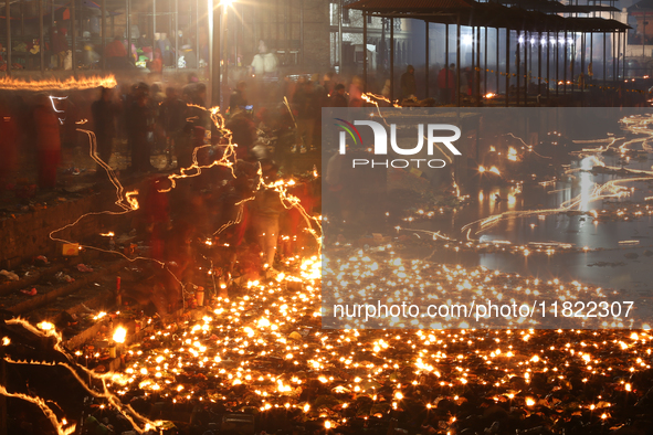 A long exposure shot shows lights set to float in the Bagmati River by Hindu devotees in Kathmandu, Nepal, on November 30, 2024, during the...