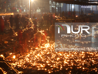 A long exposure shot shows lights set to float in the Bagmati River by Hindu devotees in Kathmandu, Nepal, on November 30, 2024, during the...