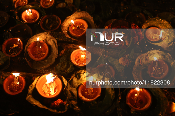 Nepali Hindu devotees light oil-fed lamps on the embankment of the Bagmati River in Kathmandu, Nepal, on November 30, 2024, on the occasion...