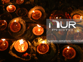 Nepali Hindu devotees light oil-fed lamps on the embankment of the Bagmati River in Kathmandu, Nepal, on November 30, 2024, on the occasion...