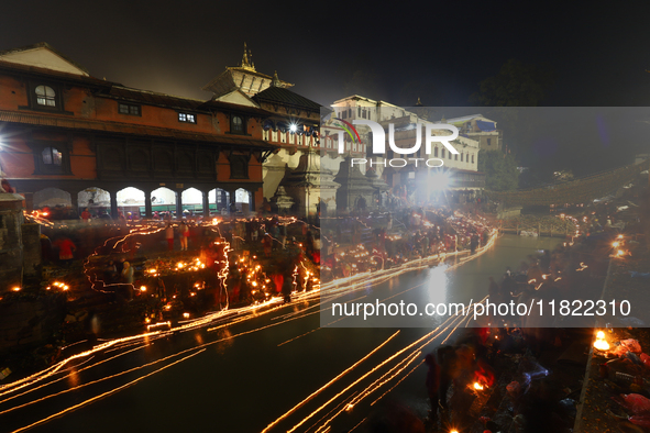 A long exposure shot shows lights set to float in the Bagmati River by Hindu devotees in Kathmandu, Nepal, on November 30, 2024, during the...