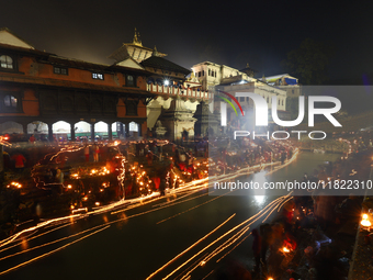 A long exposure shot shows lights set to float in the Bagmati River by Hindu devotees in Kathmandu, Nepal, on November 30, 2024, during the...