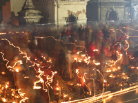 A long exposure shot shows lights set to float in the Bagmati River by Hindu devotees in Kathmandu, Nepal, on November 30, 2024, during the...