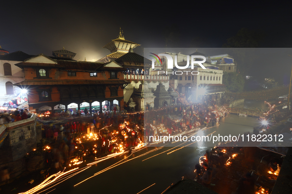 A long exposure shot shows lights set to float in the Bagmati River by Hindu devotees in Kathmandu, Nepal, on November 30, 2024, during the...