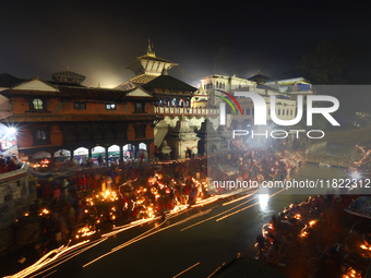 A long exposure shot shows lights set to float in the Bagmati River by Hindu devotees in Kathmandu, Nepal, on November 30, 2024, during the...