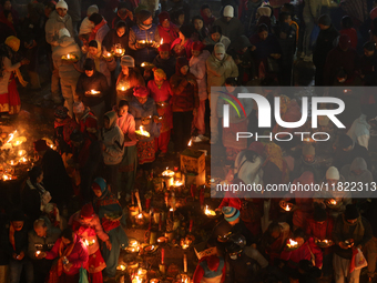 Nepali Hindu devotees light oil-fed lamps on the embankment of the Bagmati River in Kathmandu, Nepal, on November 30, 2024, on the occasion...