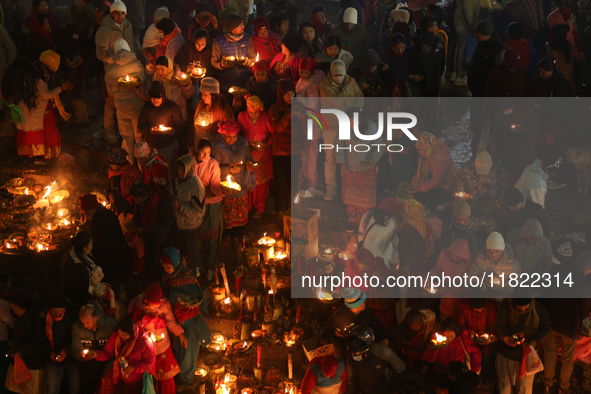 Nepali Hindu devotees light oil-fed lamps on the embankment of the Bagmati River in Kathmandu, Nepal, on November 30, 2024, on the occasion...