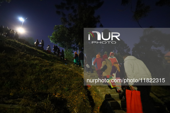 Nepali Hindu devotees climb the hill to sprinkle the ''Sat-bij,'' seven sacred seeds, on the premises of Pashupatinath Temple in Kathmandu,...