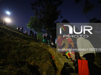 Nepali Hindu devotees climb the hill to sprinkle the ''Sat-bij,'' seven sacred seeds, on the premises of Pashupatinath Temple in Kathmandu,...