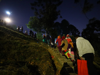 Nepali Hindu devotees climb the hill to sprinkle the ''Sat-bij,'' seven sacred seeds, on the premises of Pashupatinath Temple in Kathmandu,...