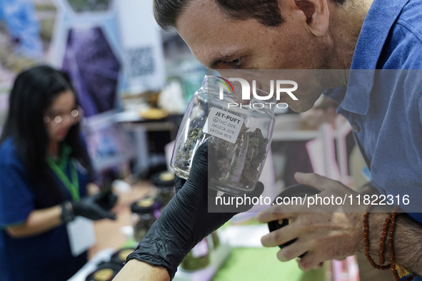 A visitor smells marijuana during the Asia International Hemp Expo (AIHE) in Bangkok, Thailand, on November 30, 2024. 