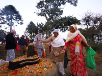 Nepali Hindu devotees offer ''Sat-bij,'' seven sacred seeds, to a Shivalinga (idol of Lord Shiva) in the premises of Pashupatinath Temple in...