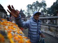 Nepali Hindu devotees offer ''Sat-bij,'' seven sacred seeds, to a Shivalinga (idol of Lord Shiva) in the premises of Pashupatinath Temple in...