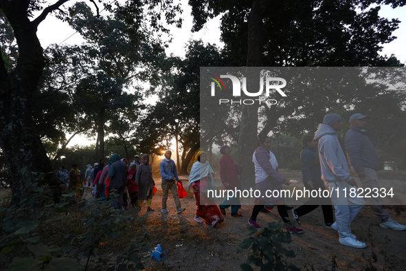 Nepali Hindu devotees offer ''Sat-bij,'' seven sacred seeds, to a Shivalinga (idol of Lord Shiva) in the premises of Pashupatinath Temple in...