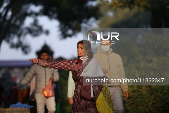 Nepali Hindu devotees offer ''Sat-bij,'' seven sacred seeds, to a Shivalinga (idol of Lord Shiva) in the premises of Pashupatinath Temple in...