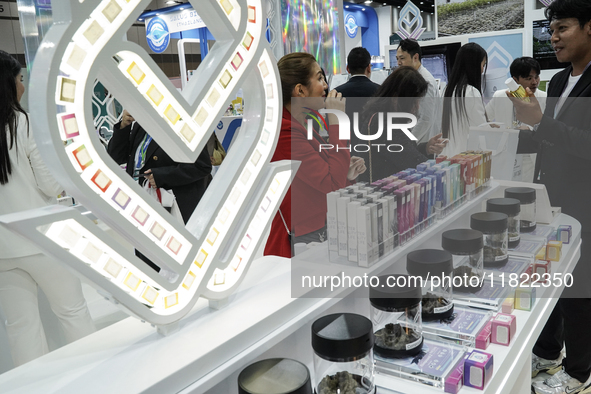 Visitors buy cannabis-infused healthcare products during the Asia International Hemp Expo (AIHE) in Bangkok, Thailand, on November 30, 2024....