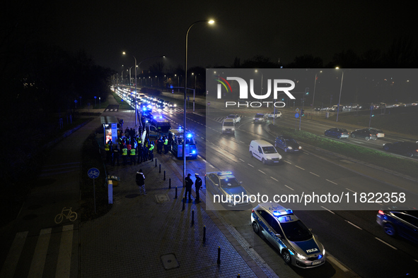 Members of the Ostatnie Pokolenie or Last Generation group block traffic on the Wybrzeze Gdanskie street in Warsaw, Poland on 27 November, 2...