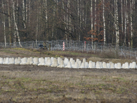 Soldiers of the Polish border guard patrol next to border posts at the Polish-Russian border in Dabrowka, Poland, on November 30, 2024. The...