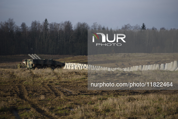 Anti-tank concrete fortifications are pictured at the Polish-Russian border as members of the Polish armed forces stand guard in Dabrowka, P...