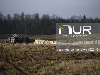 Anti-tank concrete fortifications are pictured at the Polish-Russian border as members of the Polish armed forces stand guard in Dabrowka, P...