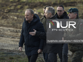 Polish Prime Minister Donald Tusk (center left) and Deputy Minister of National Defense Cezary Tomczyk (center right) talk before a press co...