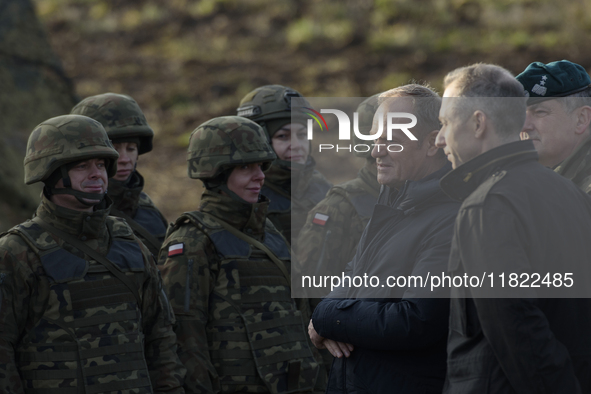 Polish Prime Minister Donald Tusk (left) and Deputy Minister of National Defense Cezary Tomczyk (right) talk before a press conference in Da...