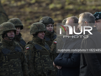 Polish Prime Minister Donald Tusk (left) and Deputy Minister of National Defense Cezary Tomczyk (right) talk before a press conference in Da...