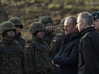 Polish Prime Minister Donald Tusk (left) and Deputy Minister of National Defense Cezary Tomczyk (right) talk before a press conference in Da...