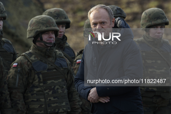 Polish Prime Minister Donald Tusk visits members of the Polish armed forces at the Polish-Russian border in Dabrowka, Poland, on November 30...